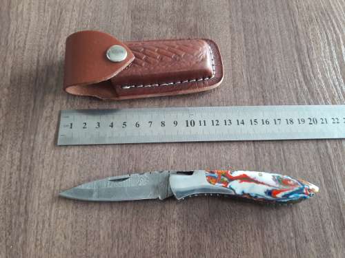 Handmade Damascus steel folding knife with Resin handle scales.