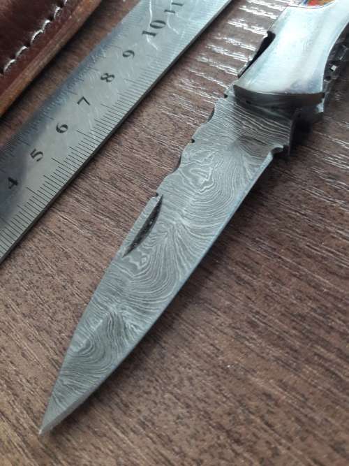 Handmade Damascus steel folding knife with Resin handle scales.