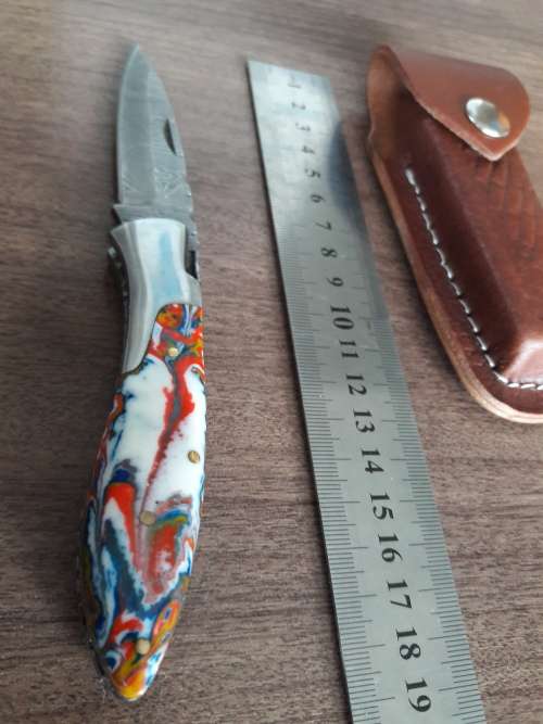 Handmade Damascus steel folding knife with Resin handle scales.