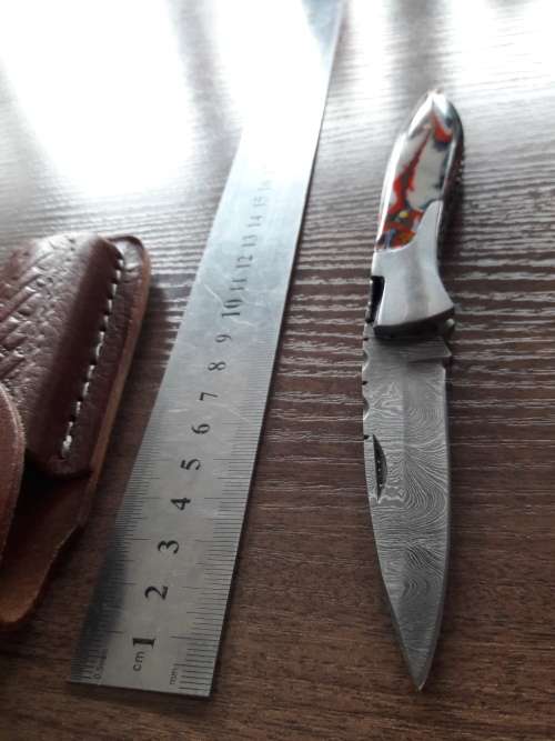 Handmade Damascus steel folding knife with Resin handle scales.