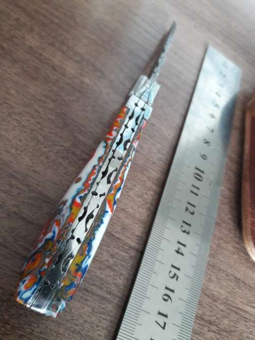 Handmade Damascus steel folding knife with Resin handle scales.
