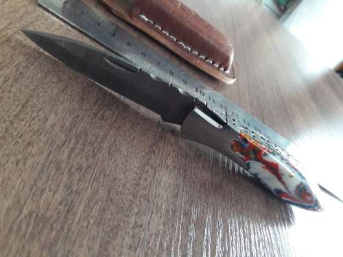 Handmade Damascus steel folding knife with Resin handle scales.