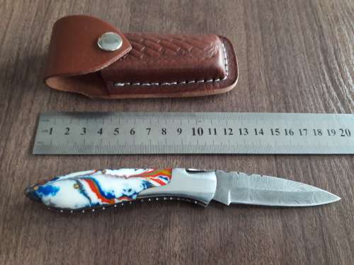 Handmade Damascus steel folding knife with Resin handle scales.