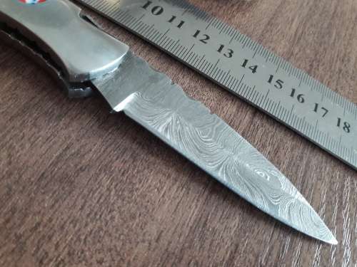 Handmade Damascus steel folding knife with Resin handle scales.