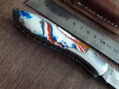 Handmade Damascus steel folding knife with Resin handle scales.