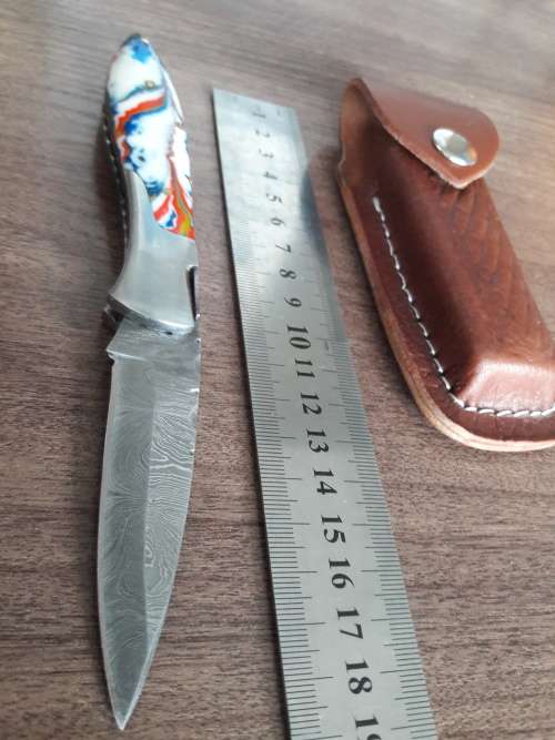 Handmade Damascus steel folding knife with Resin handle scales.