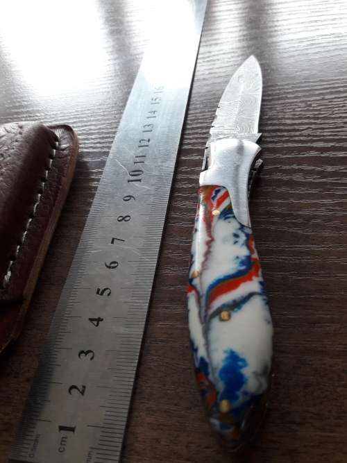 Handmade Damascus steel folding knife with Resin handle scales.