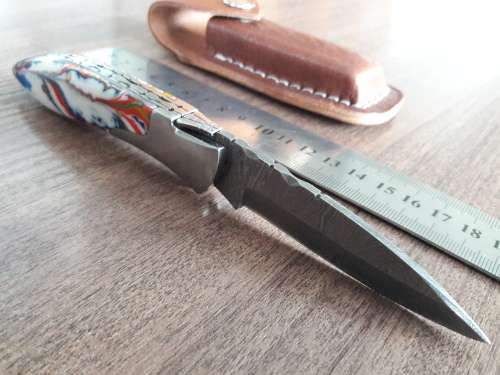Handmade Damascus steel folding knife with Resin handle scales.