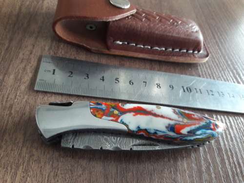 Handmade Damascus steel folding knife with Resin handle scales.