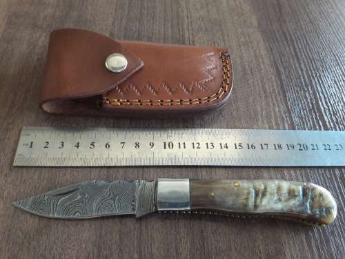 Handmade Damascus steel folding knife with RAM HORN handle scales.