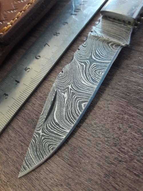 Handmade Damascus steel folding knife with RAM HORN handle scales.