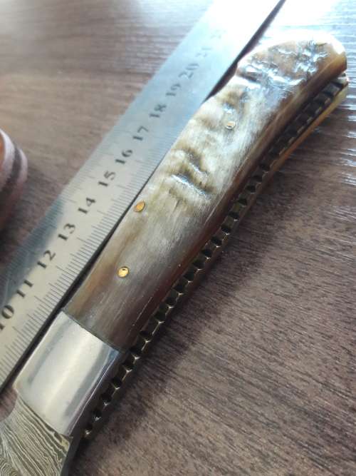 Handmade Damascus steel folding knife with RAM HORN handle scales.