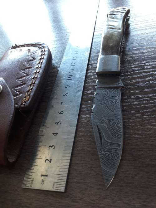 Handmade Damascus steel folding knife with RAM HORN handle scales.