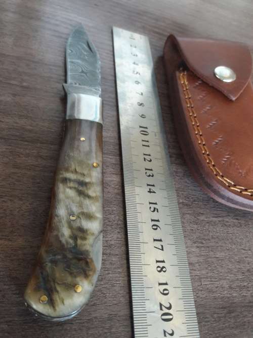 Handmade Damascus steel folding knife with RAM HORN handle scales.