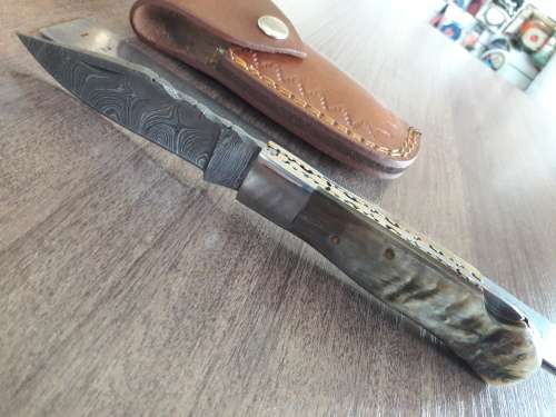 Handmade Damascus steel folding knife with RAM HORN handle scales.