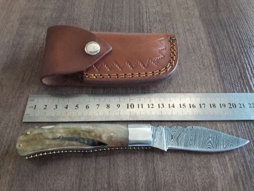 Handmade Damascus steel folding knife with RAM HORN handle scales.