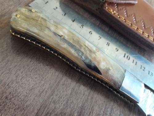 Handmade Damascus steel folding knife with RAM HORN handle scales.