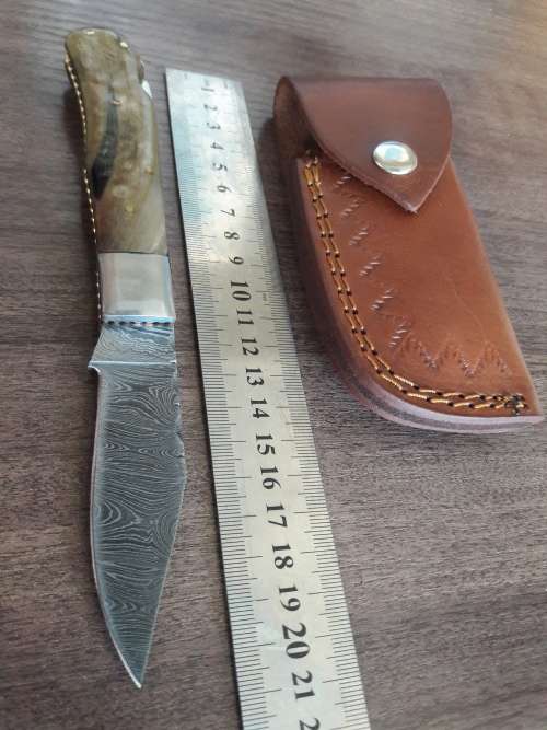 Handmade Damascus steel folding knife with RAM HORN handle scales.