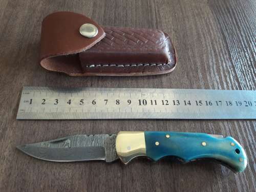 Handmade Damascus steel folding knife with Camel Bone handle scales.