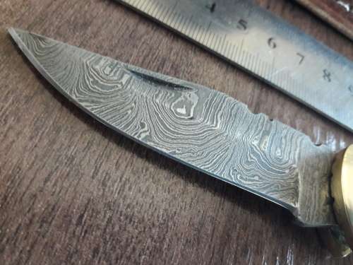 Handmade Damascus steel folding knife with Camel Bone handle scales.
