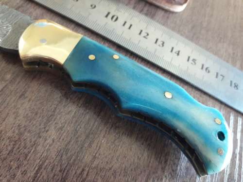 Handmade Damascus steel folding knife with Camel Bone handle scales.
