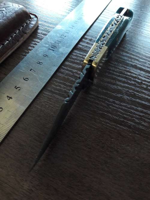 Handmade Damascus steel folding knife with Camel Bone handle scales.