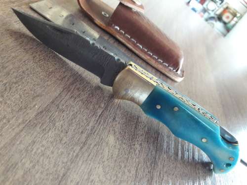 Handmade Damascus steel folding knife with Camel Bone handle scales.