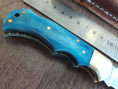 Handmade Damascus steel folding knife with Camel Bone handle scales.