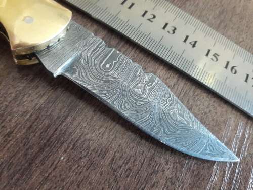 Handmade Damascus steel folding knife with Camel Bone handle scales.
