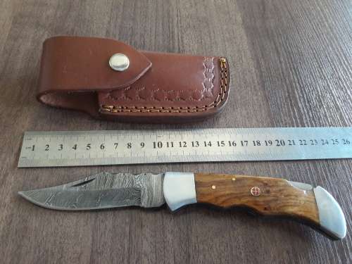 Handmade Damascus steel folding knife with Wooden handle scales.
