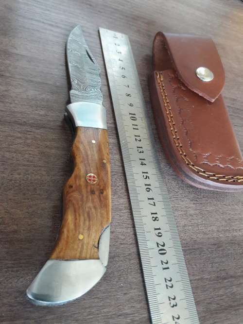 Handmade Damascus steel folding knife with Wooden handle scales.