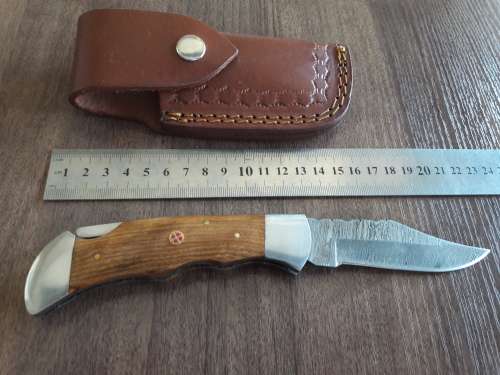 Handmade Damascus steel folding knife with Wooden handle scales.