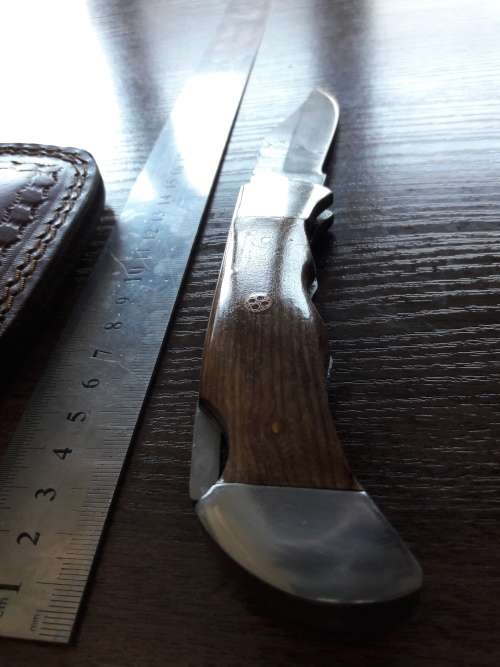 Handmade Damascus steel folding knife with Wooden handle scales.