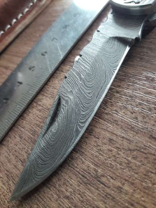 Handmade Damascus steel folding knife with Wooden handle scales.