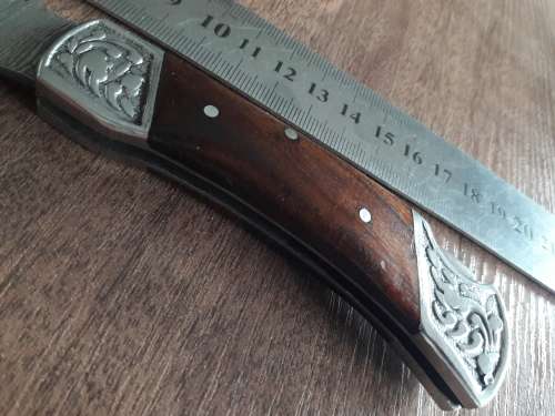 Handmade Damascus steel folding knife with Wooden handle scales.