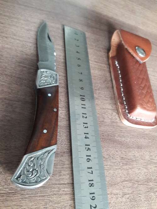 Handmade Damascus steel folding knife with Wooden handle scales.