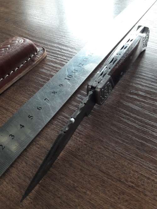 Handmade Damascus steel folding knife with Wooden handle scales.