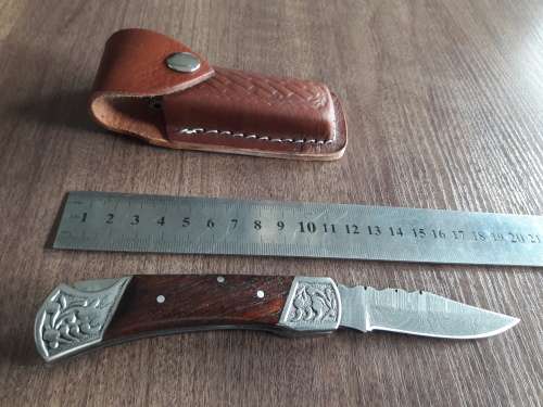 Handmade Damascus steel folding knife with Wooden handle scales.