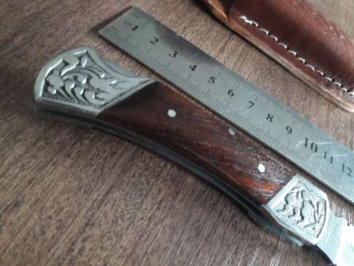 Handmade Damascus steel folding knife with Wooden handle scales.