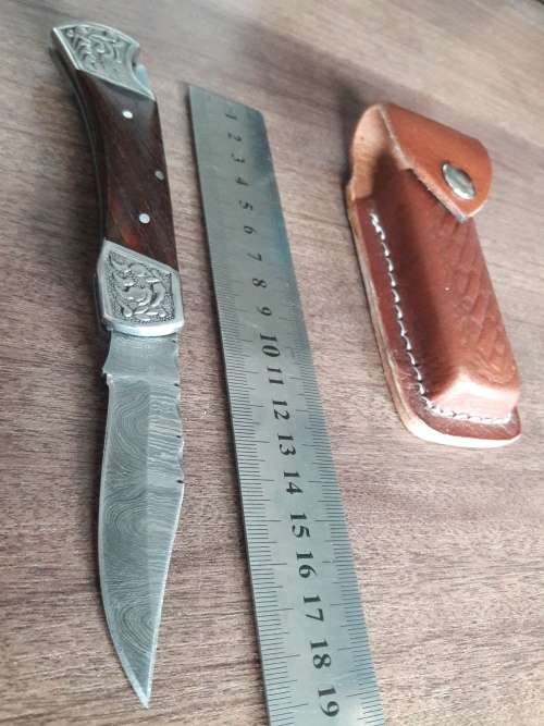 Handmade Damascus steel folding knife with Wooden handle scales.
