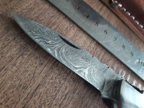 Handmade Damascus steel folding knife with Wooden handle scales.
