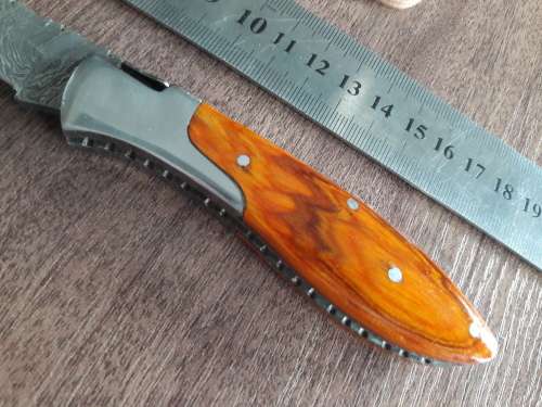 Handmade Damascus steel folding knife with Wooden handle scales.