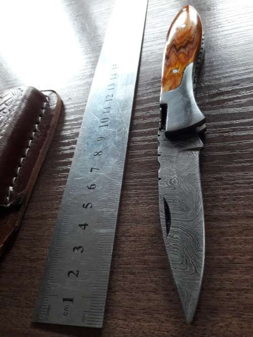 Handmade Damascus steel folding knife with Wooden handle scales.