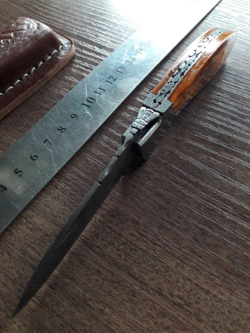 Handmade Damascus steel folding knife with Wooden handle scales.