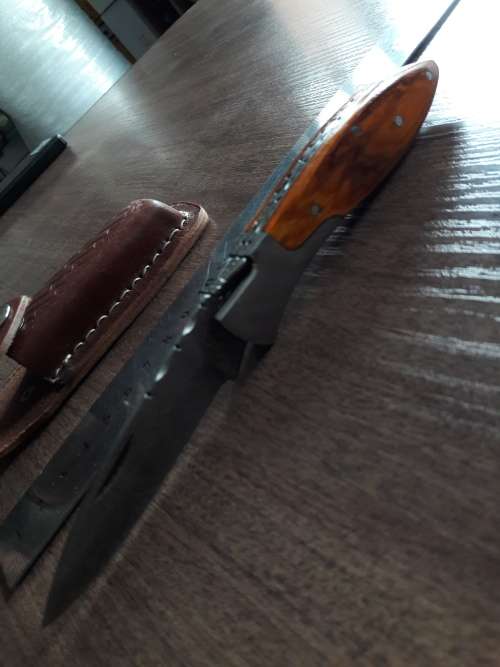 Handmade Damascus steel folding knife with Wooden handle scales.