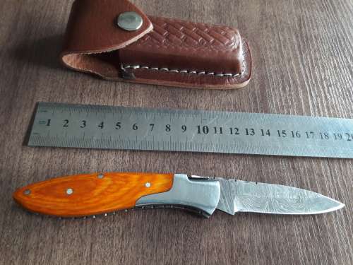 Handmade Damascus steel folding knife with Wooden handle scales.