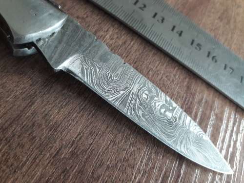 Handmade Damascus steel folding knife with Wooden handle scales.