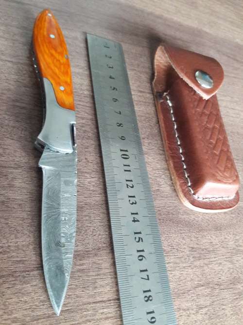 Handmade Damascus steel folding knife with Wooden handle scales.
