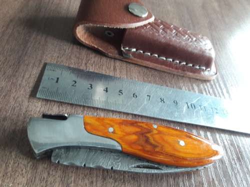 Handmade Damascus steel folding knife with Wooden handle scales.