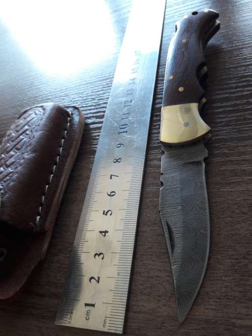 Handmade Damascus steel folding knife with Wooden handle scales.